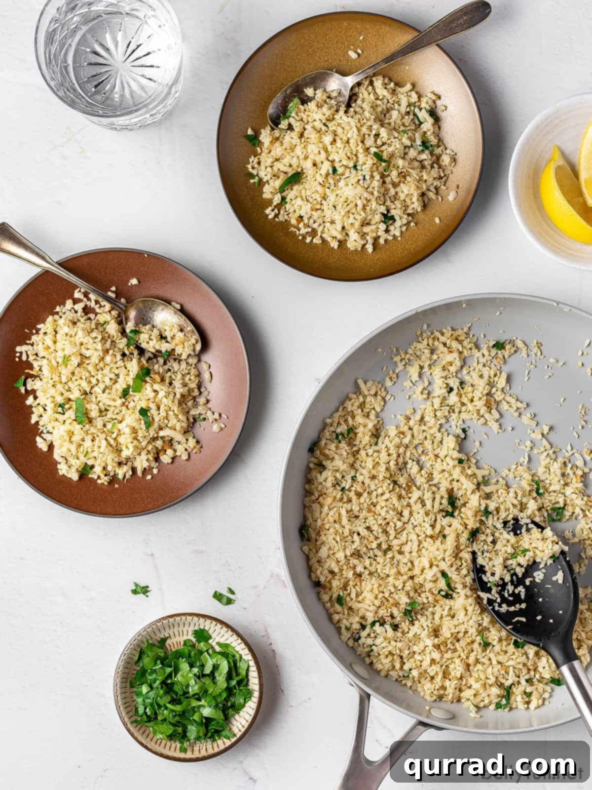Wholesome Cauliflower Grains 3 Cauliflower rice being cooked in a skillet, with two prepared bowls on the side.