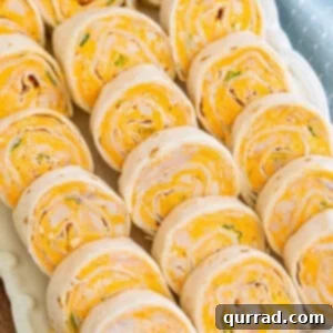 Overhead view of buffalo chicken roll-ups on a white platter