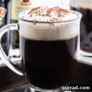 Warm Irish Embrace 6 tall glass mug of Irish Coffee garnished with chocolate shavings