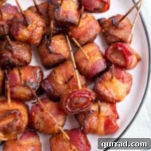 Overhead view of bacon wrapped water chestnuts on a white plate