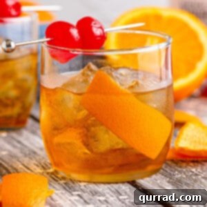 Timeless Elegance 6 Side view of an old fashioned cocktail with orange peel and cherries