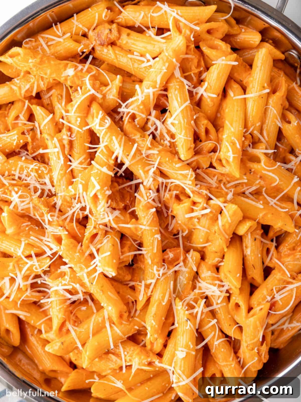 Overhead view of penne alla vodka topped with parmesan