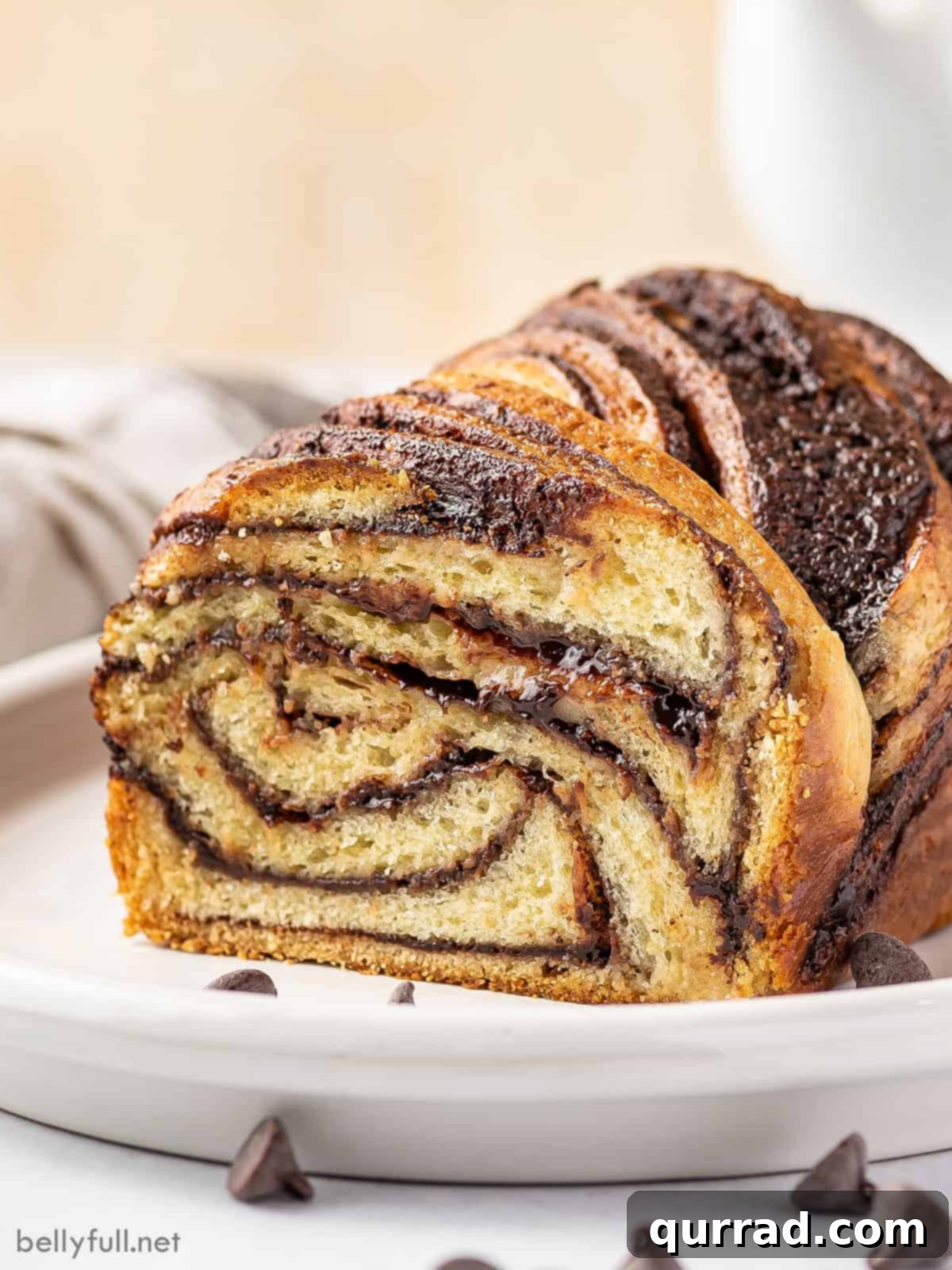 Decadent Chocolate Babka 8 A close-up of a slice of babka, beautifully showcasing the intricate swirl of chocolate filling within the soft bread.