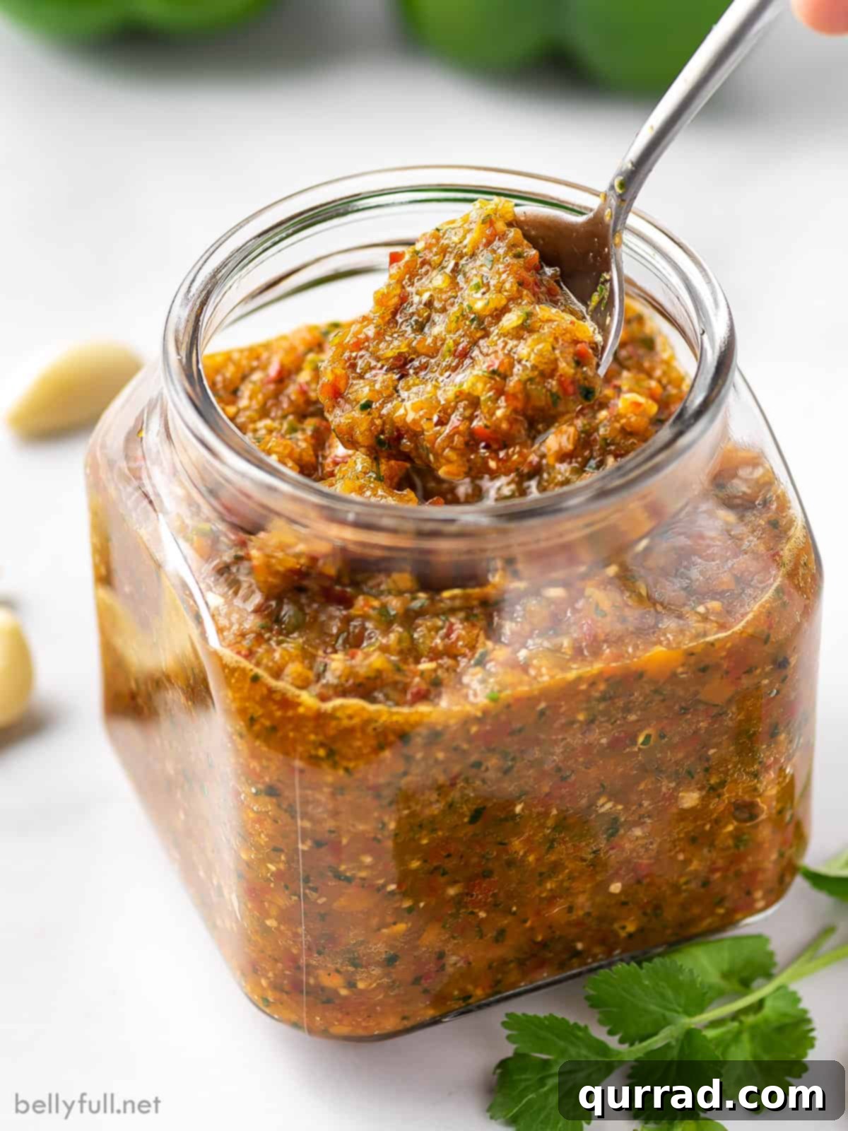 The Flavorful Foundation 5 Overhead shot of a jar of homemade Puerto Rican Sofrito, with a spoon revealing its thick texture, ready for cooking.
