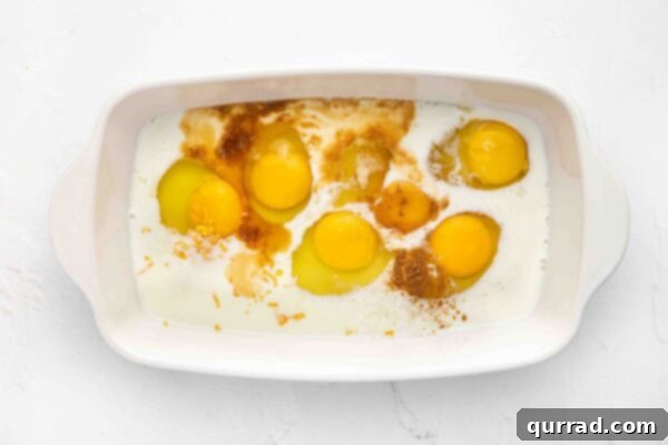 Decadent Challah French Toast 4 Ingredients for French Toast custard: eggs, milk, honey, orange zest, and cinnamon in a casserole dish.
