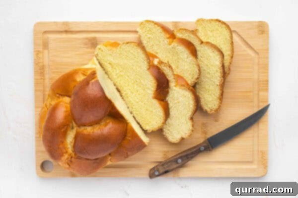Decadent Challah French Toast 6 Sliced loaf of challah bread on a cutting board, showing the ideal thickness.