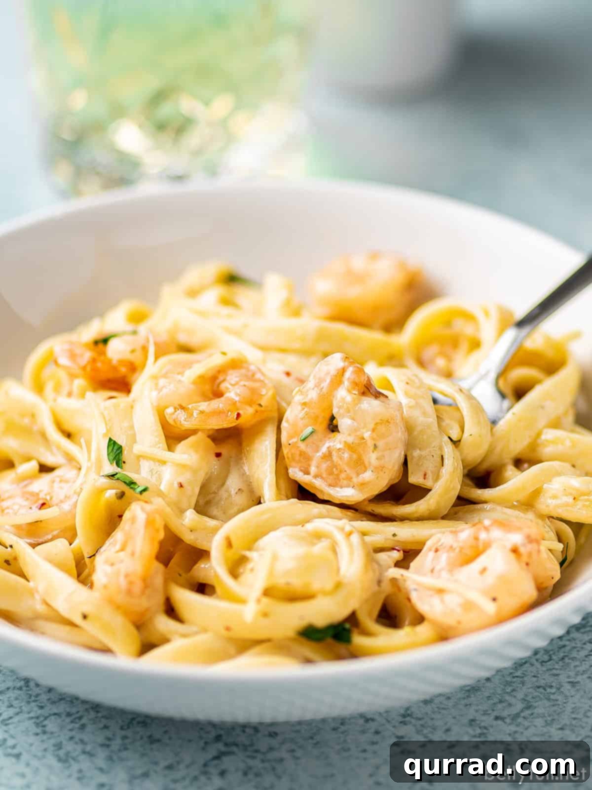 Creamy Garlic Shrimp Alfredo 5 creamy pasta with shrimp on fork in white bowl