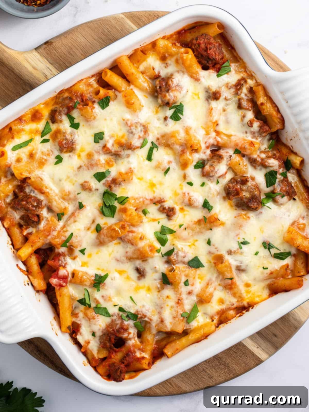 Overhead view of baked ziti in a square casserole dish