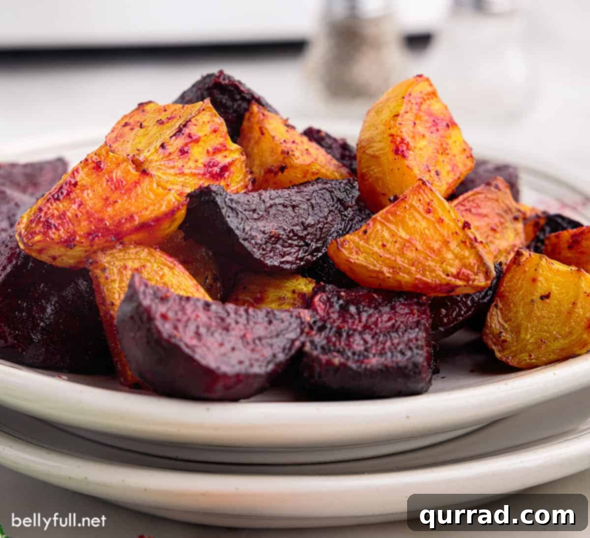 Crispy Air-Fried Beet Bites 4 Beautifully roasted red and golden beets served on stacked white plates, ready to enjoy.