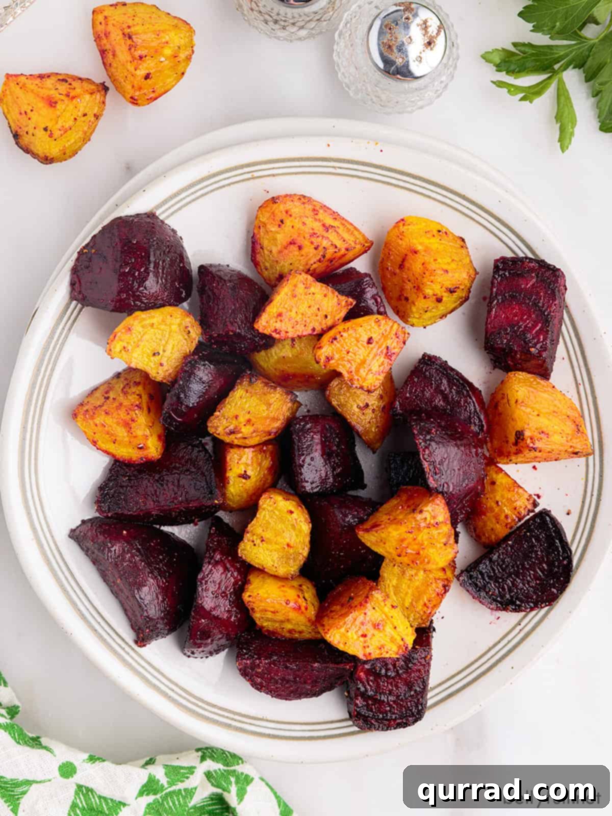 Crispy Air-Fried Beet Bites 5 Delicious cubes of air fryer beets presented beautifully on a pristine white plate.