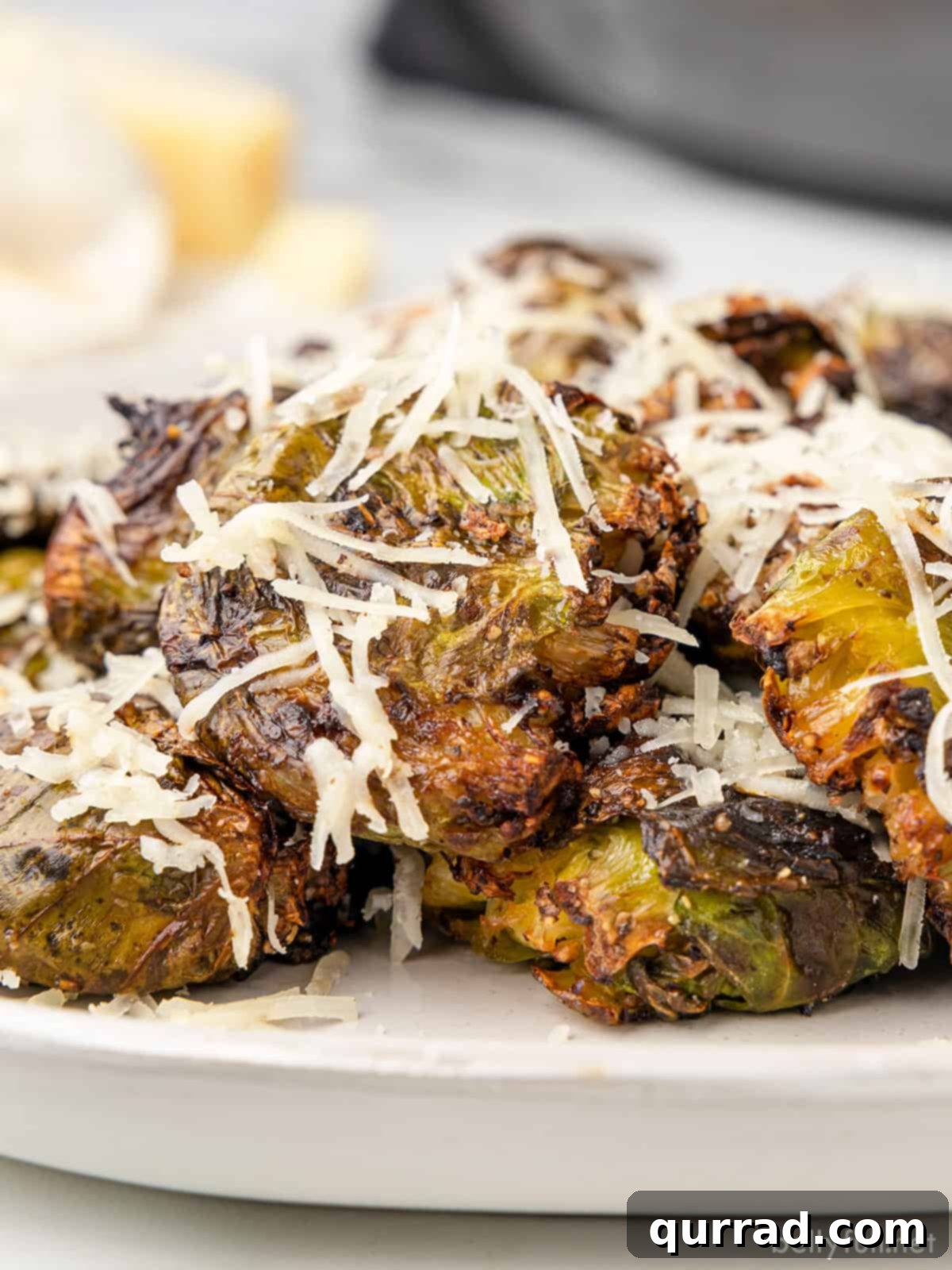 Angled view of air fryer brussels sprouts topped with parmesan