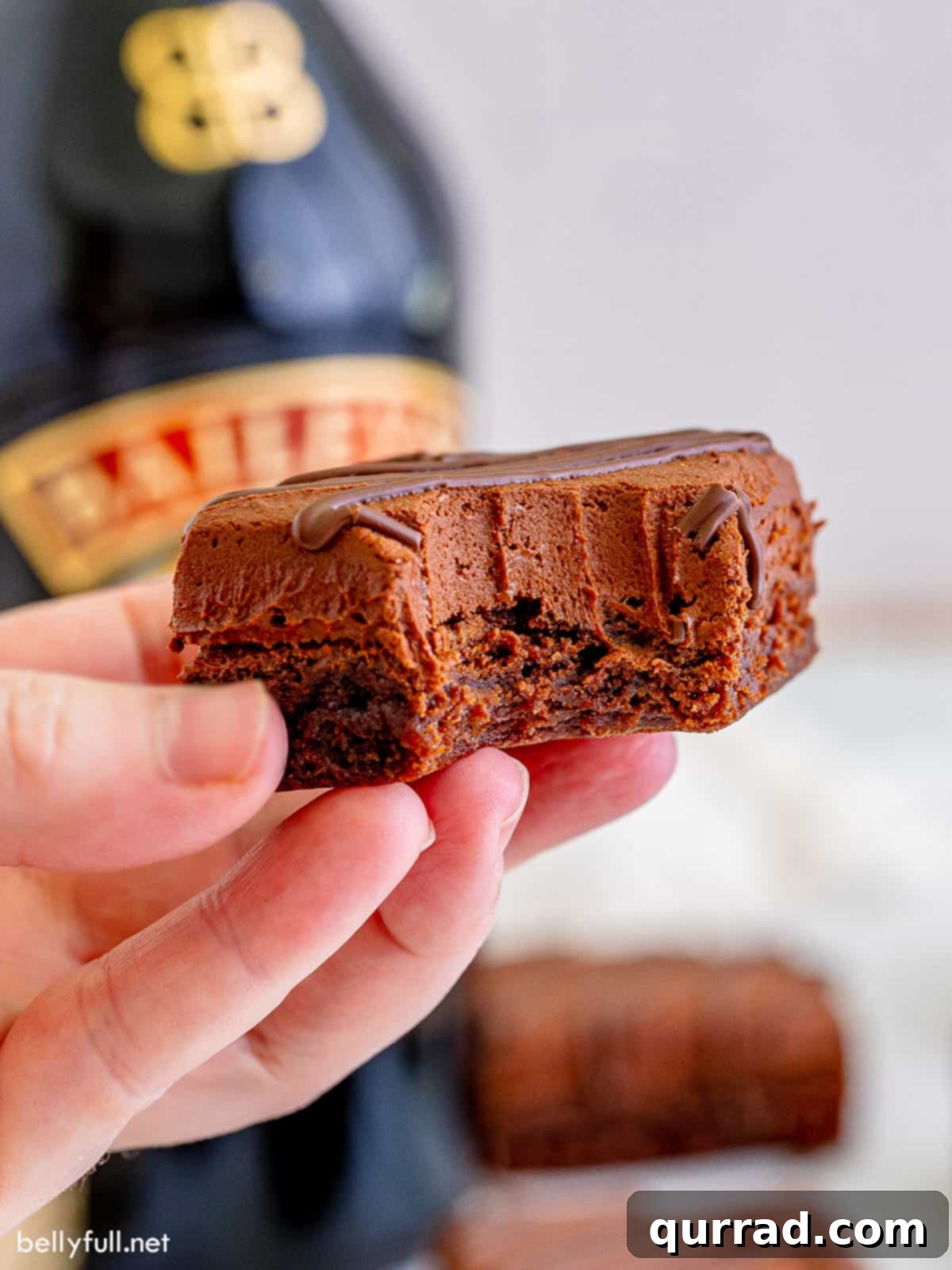 Decadent Irish Cream Brownies 2 Bailey's brownie with bite taken being held in the air