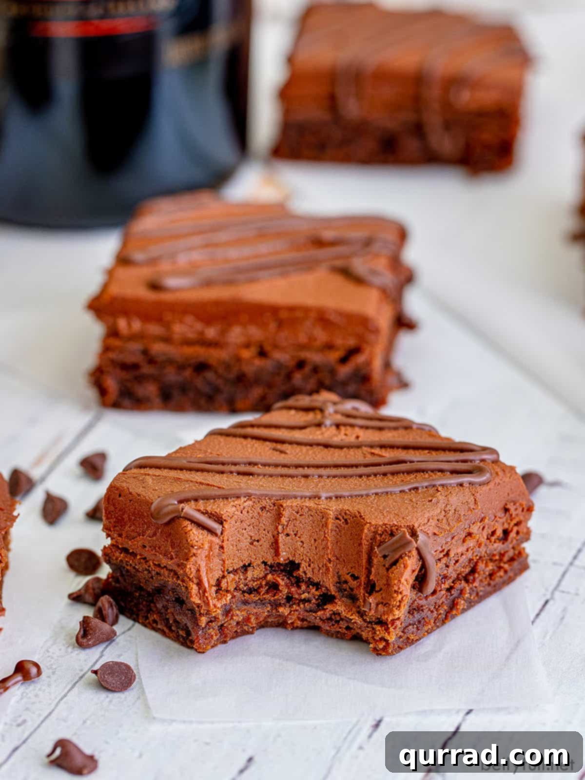 Decadent Irish Cream Brownies 5 Baileys Brownie on parchment paper with bite taken