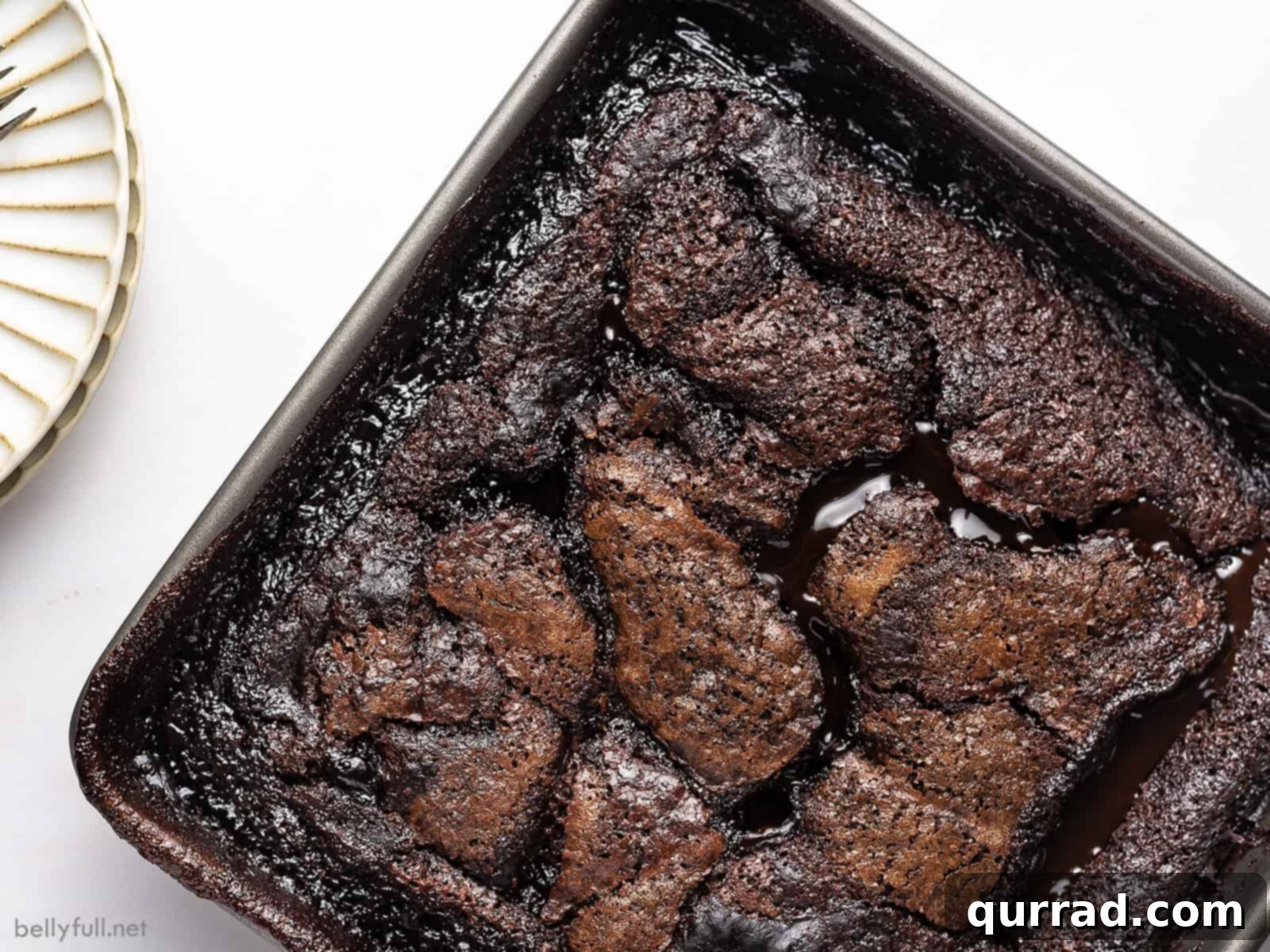 Decadent Chocolate Cobbler 3 An inviting overhead shot of a freshly baked chocolate cobbler in a square baking pan, showcasing its rich, dark surface and ready to be served.