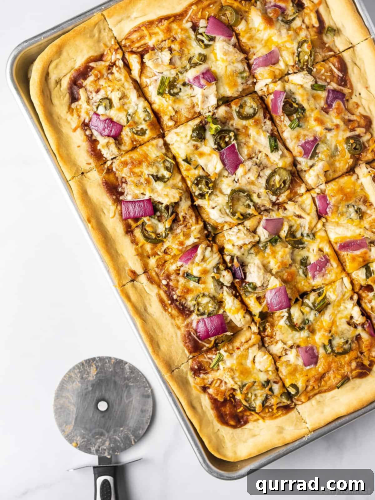 Signature BBQ Chicken Pizza 5 Close-up overhead shot of a cooked BBQ chicken pizza, emphasizing the melted cheese, tender chicken, and vibrant toppings, ready to be sliced.