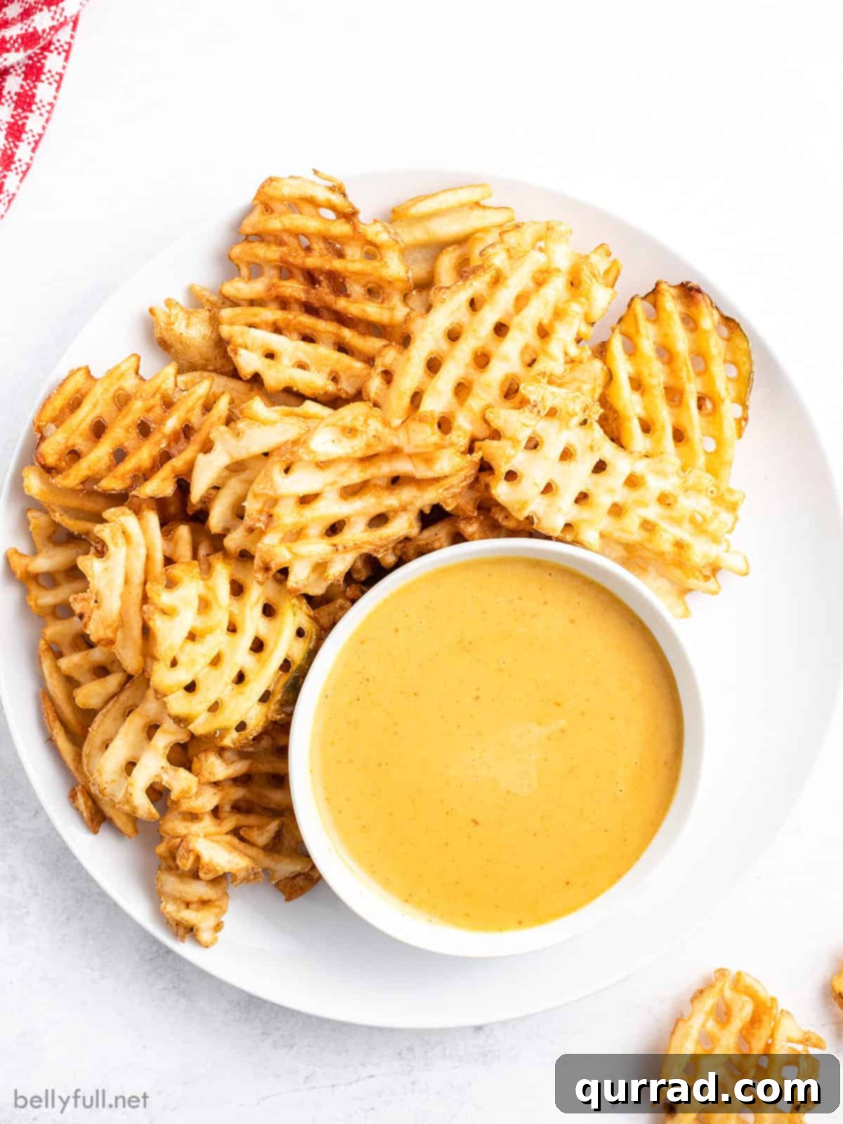 Homemade Chick-fil-A Style Sauce 2 Overhead view of chick-fil-a sauce on a plate with waffle fries, showcasing its creamy texture