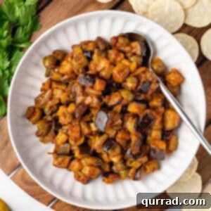 overhead caponata in white bowl with spoon