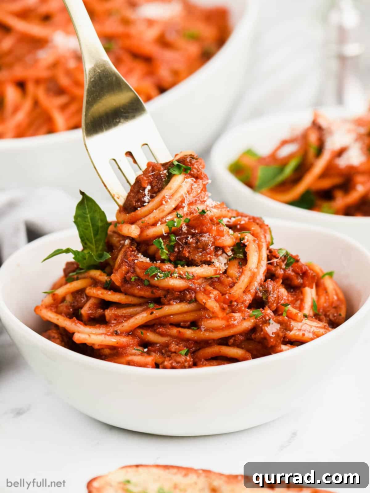 Delicious Instant Pot Spaghetti and Meat Sauce A fork twirling noodles in a bowl of homemade Instant Pot spaghetti and meat sauce, ready to be enjoyed.