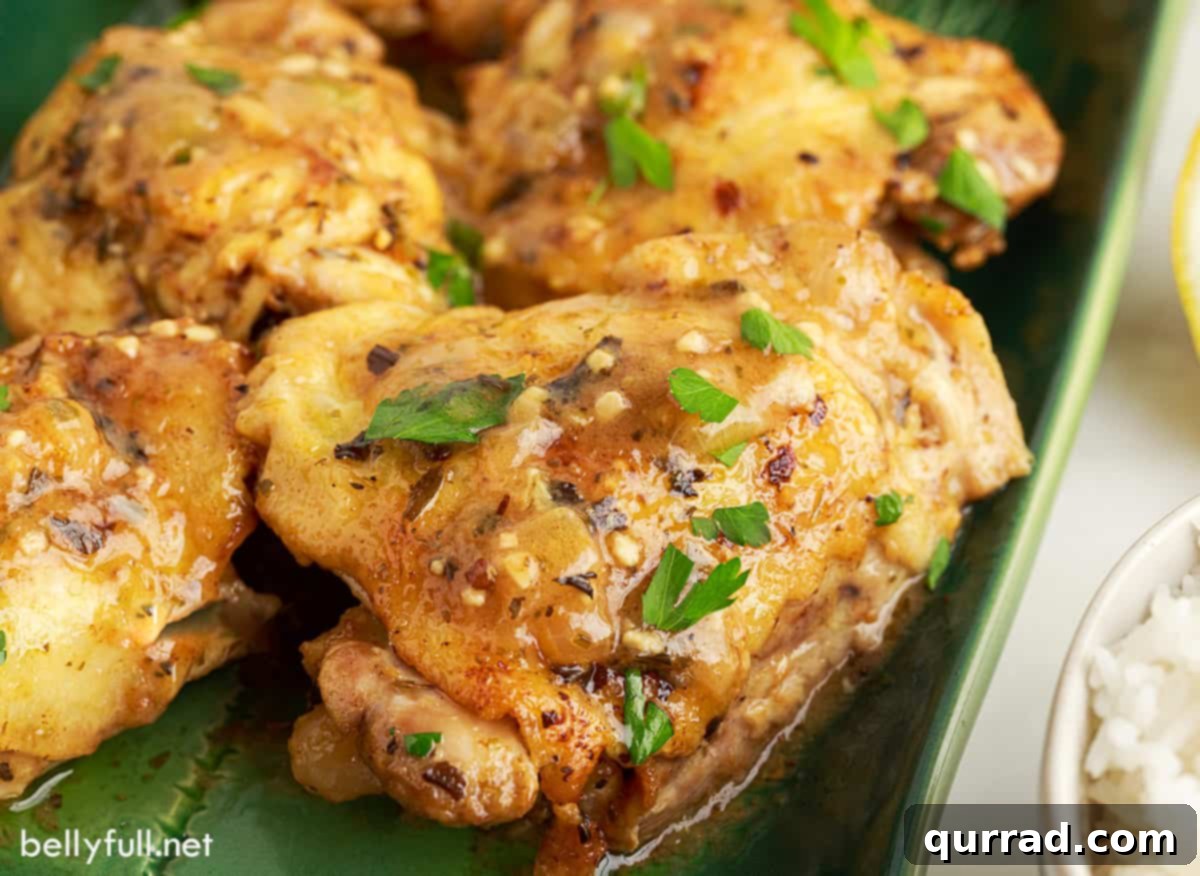 Succulent Instant Pot Lemon Butter Chicken Thighs 3 An angled shot of succulent Instant Pot lemon butter chicken thighs, served on a stylish green serving tray, ready to be enjoyed.