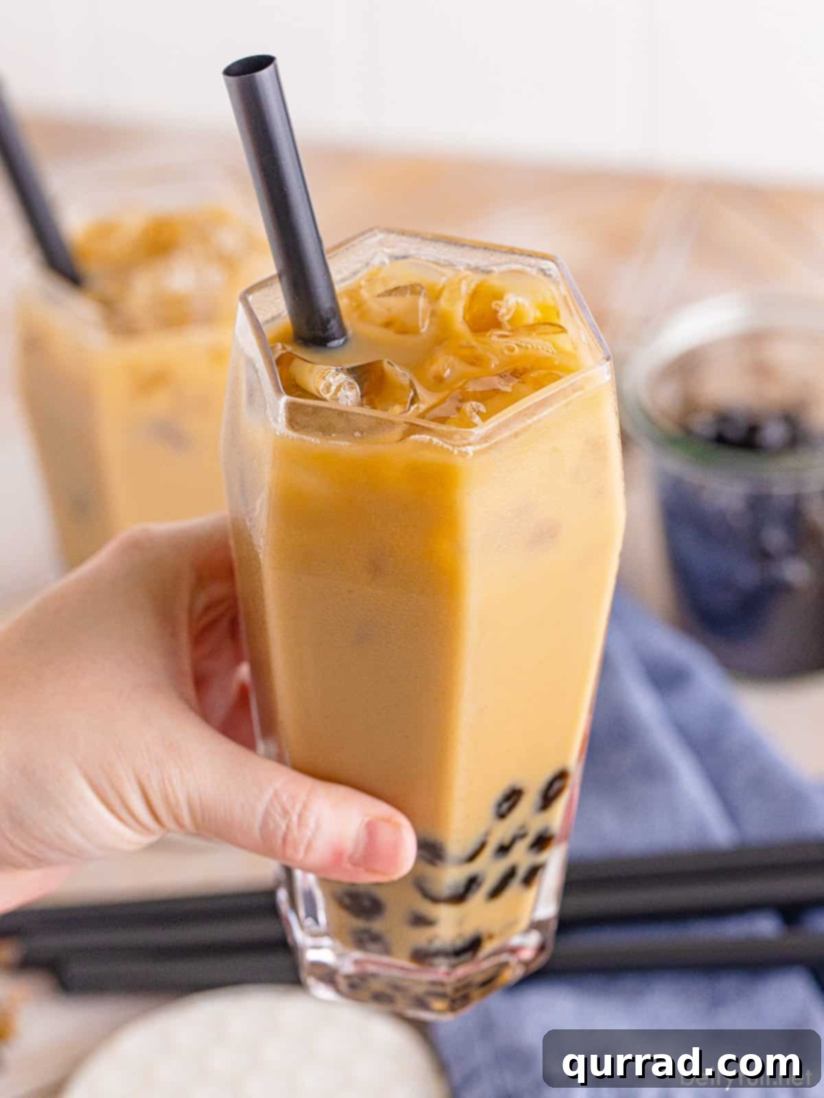 Bubble Tea Bliss 9 A hand holding a big glass of boba tea with a straw