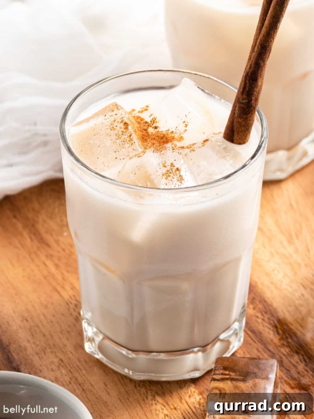 Creamy Cinnamon Mexican Horchata 2 Cinnamon infused rice milk over ice in a glass with cinnamon sticks.
