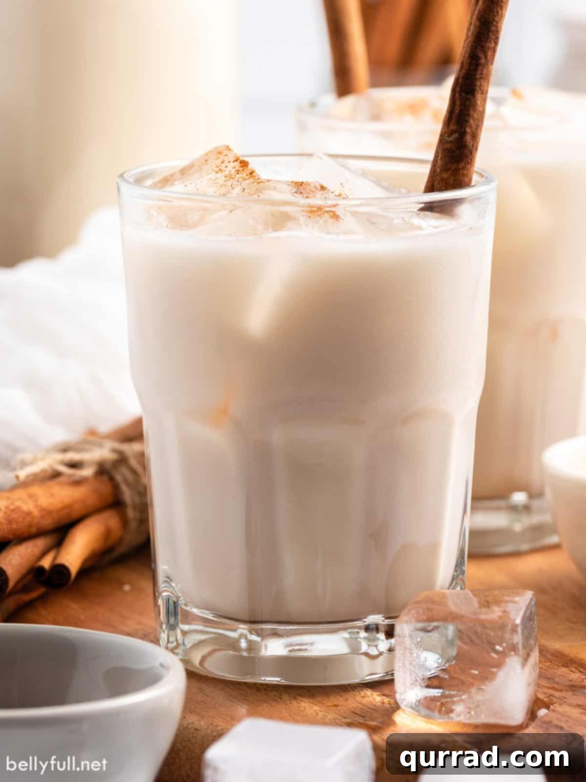 Creamy Cinnamon Mexican Horchata 8 Mexican Horchata in a glass with ice and a cinnamon stick.