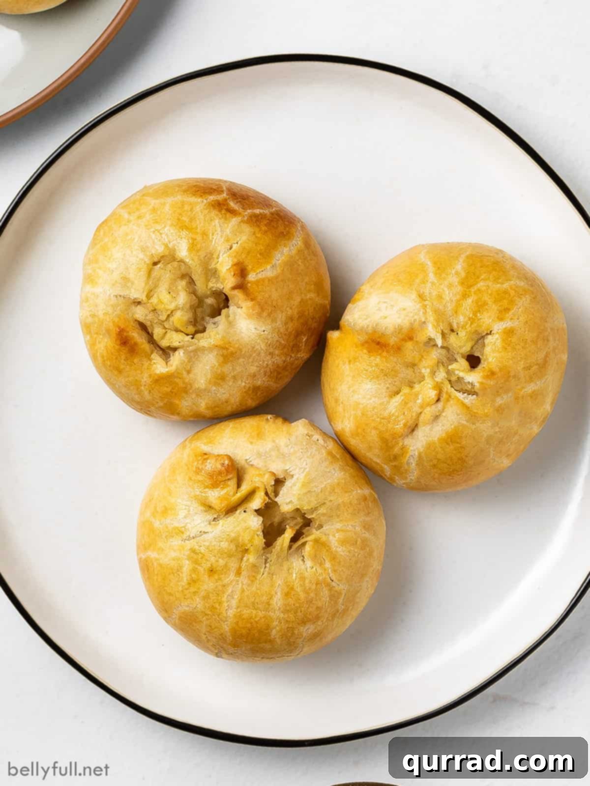 Flaky Potato Pastry 2 overhead 3 round baked potato filled pastries on white plate