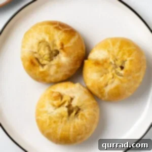 Flaky Potato Pastry 9 overhead 3 round baked potato filled pastries on white plate