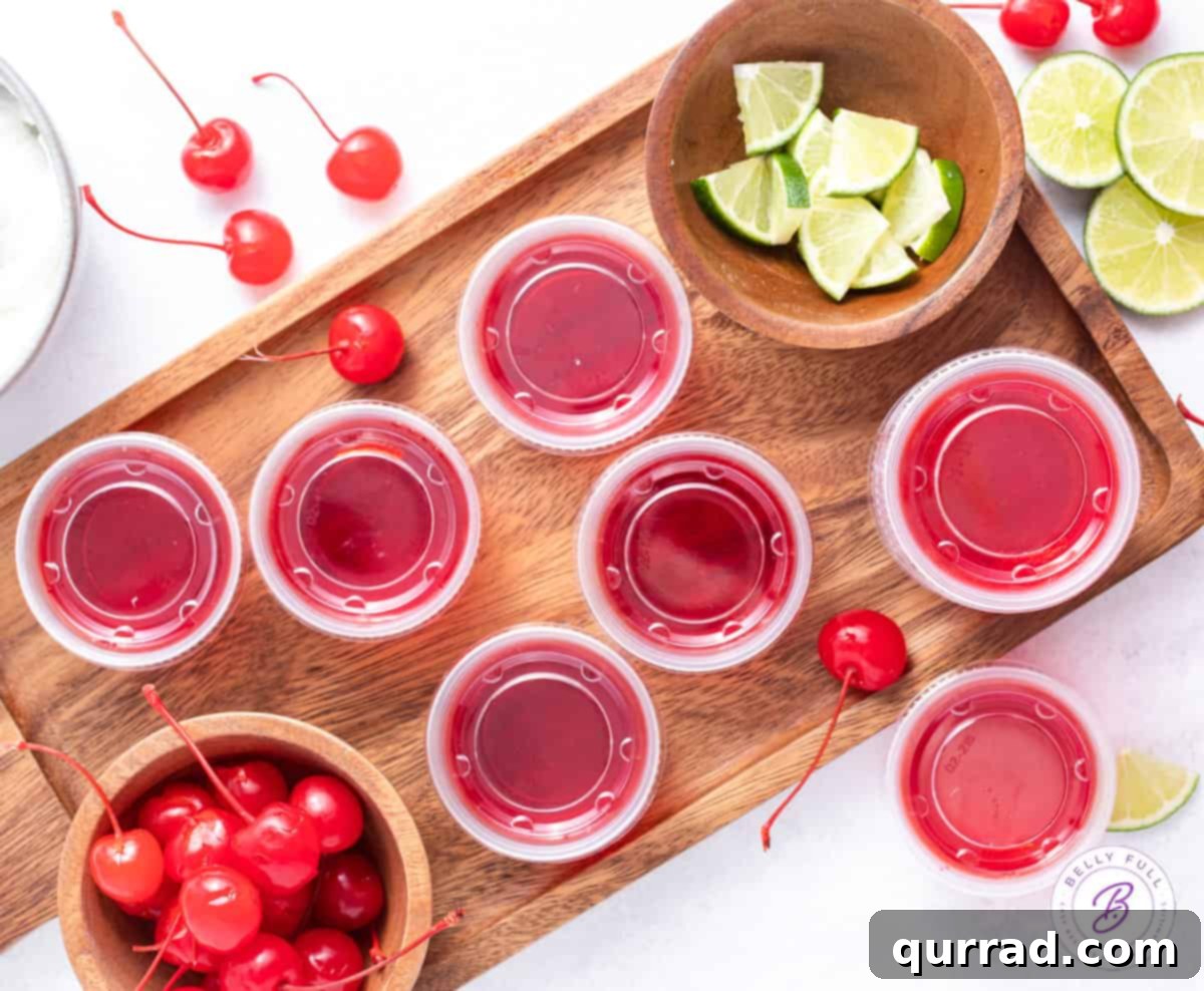 Tipsy Shirley Gel Bites 3 overhead cherry jello shots on wooden serving tray