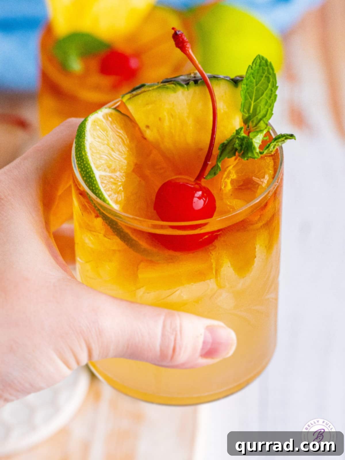 Tropical Bliss in a Glass 5 A hand gracefully holding a Mai Tai drink, highlighting its refreshing appeal and beautiful garnishes.
