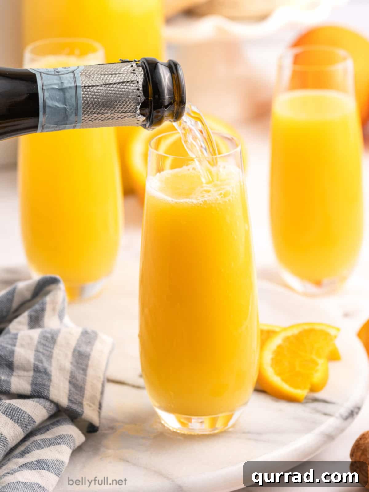 Tropical Sunrise Mimosa 3 Sparkling wine being poured into a champagne flute, ready for a delicious mimosa