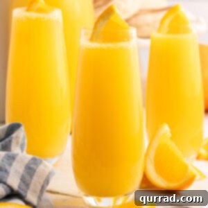 Tropical Sunrise Mimosa 5 3 glasses of Pineapple Mimosas with orange slice garnish