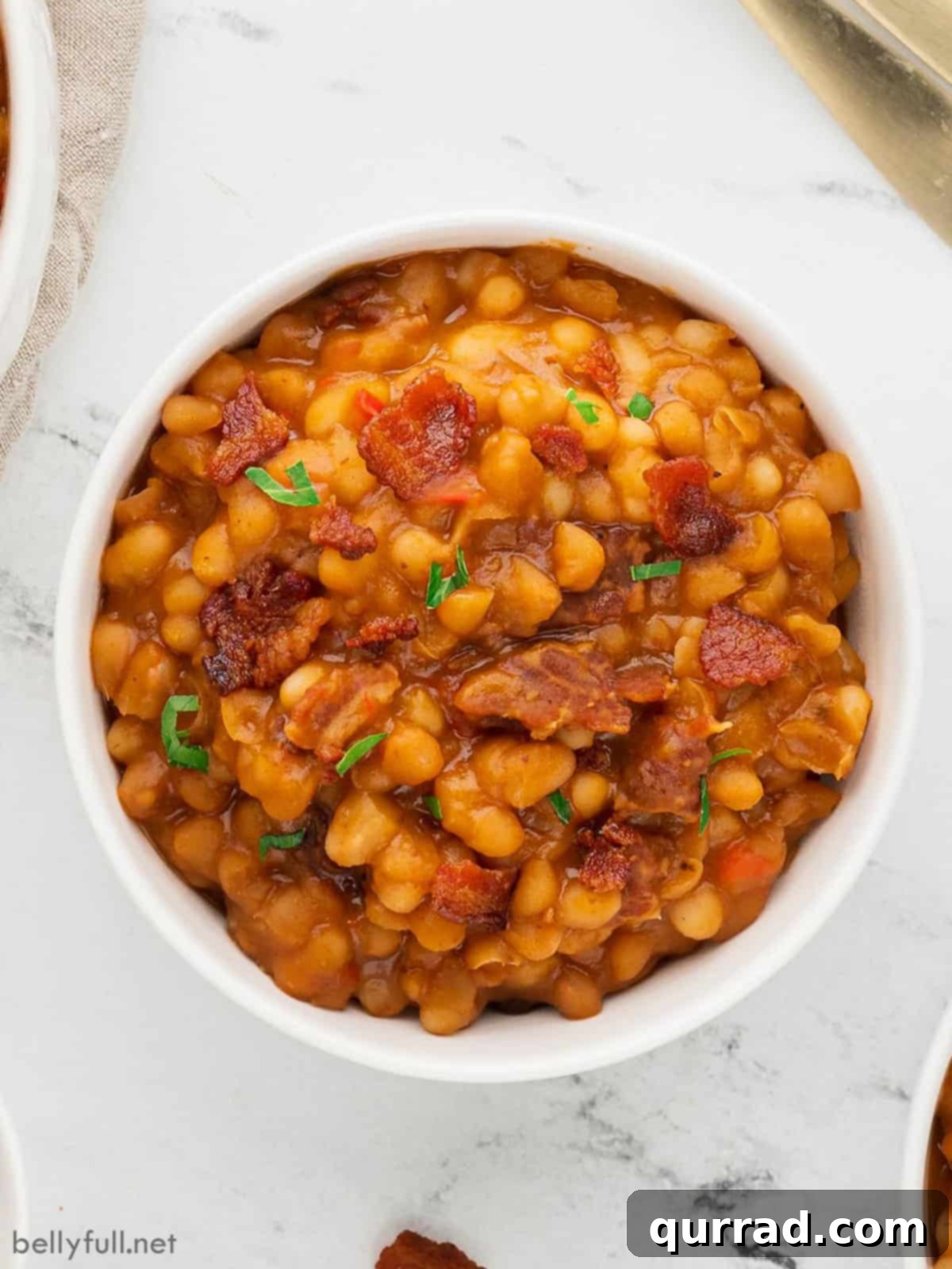 Instant Pot Baked Bean Magic 2 Overhead view of a bowl of Instant Pot baked beans garnished with fresh parsley.