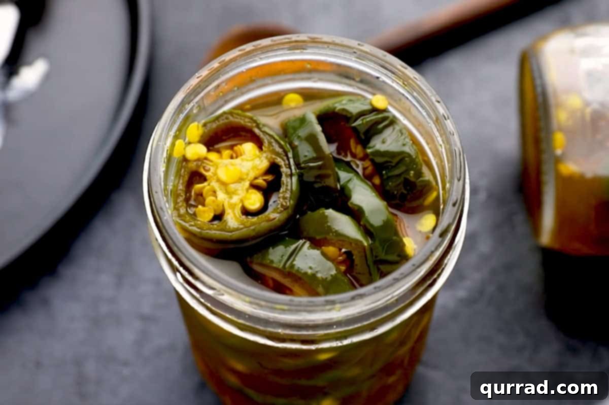 Cowboy Candy 9 Overhead view of a glass jar filled with vibrant Candied Jalapeños (Cowboy Candy).