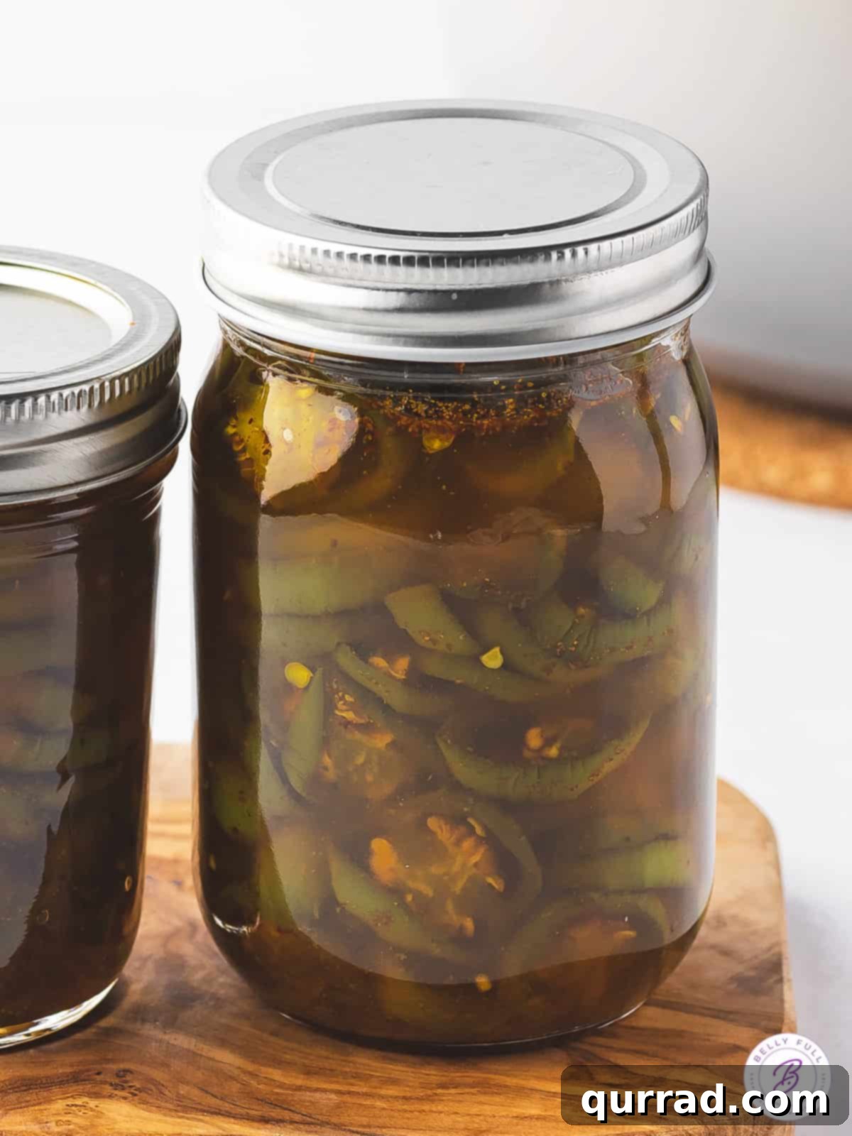 Cowboy Candy 11 A jar of candied jalapenos with the lid on, showcasing the finished product.