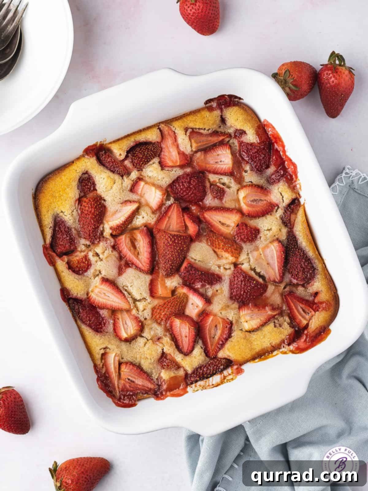 Sweet Summer Strawberry Cobbler 3 Overhead view of a freshly baked strawberry cobbler in a white rectangular baking dish