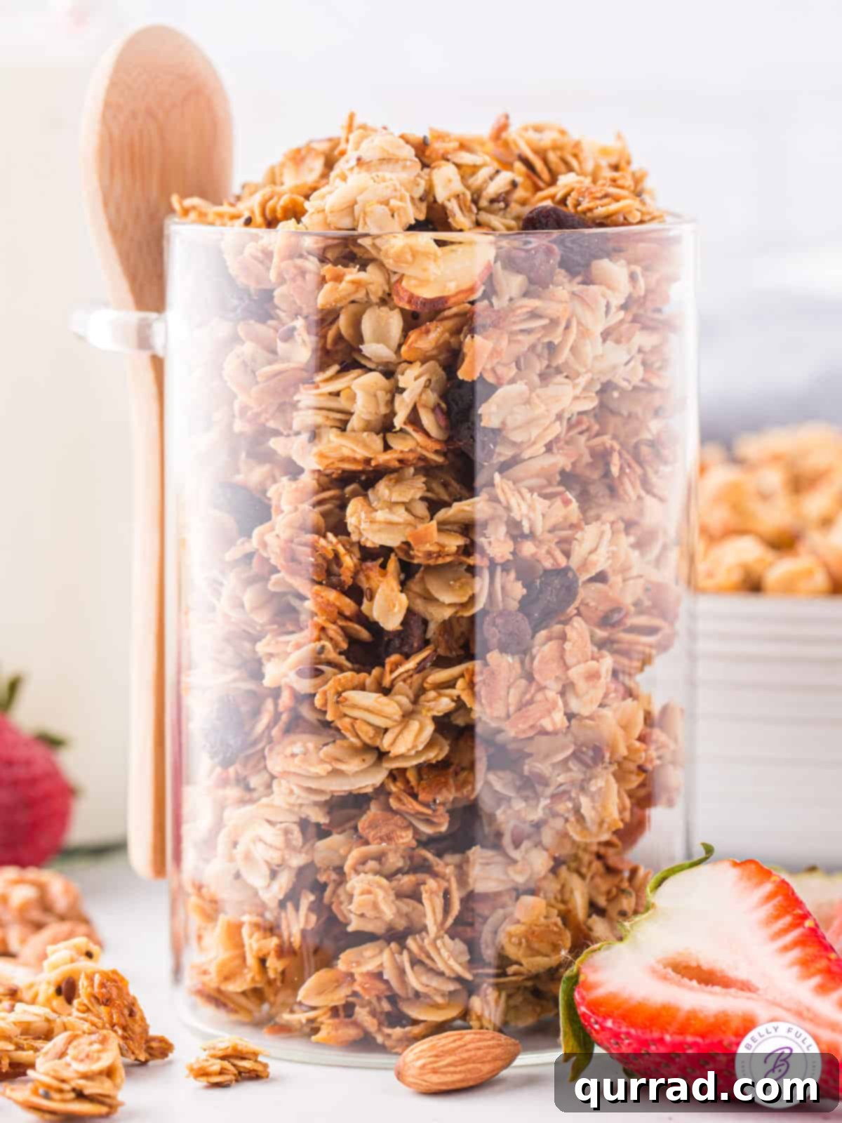 Golden Granola Crunch 3 Homemade granola stored in a large, clear glass jar, demonstrating its freshness and inviting appearance