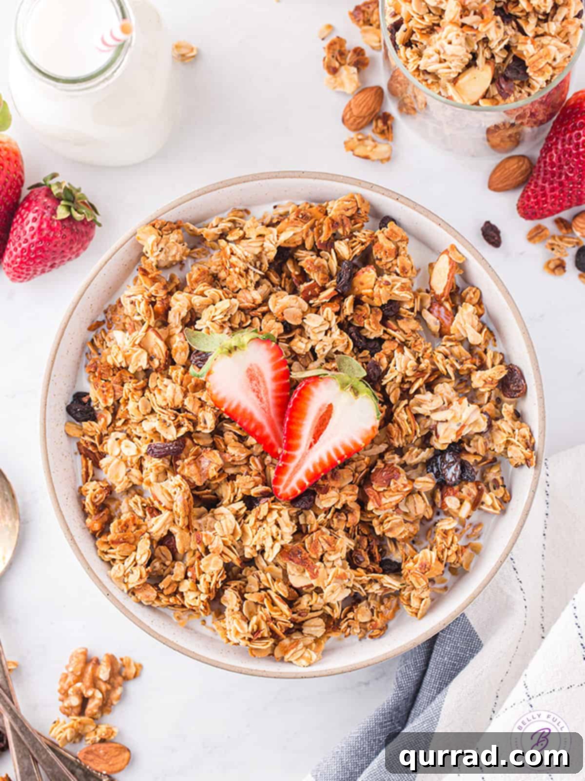 Golden Granola Crunch 5 A bowl of homemade granola generously topped with fresh strawberries, ready to be served for breakfast
