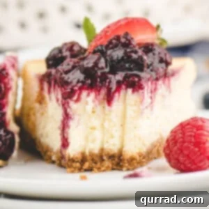 Flawless Instant Pot Cheesecake 6 A slice of vanilla bean cheesecake topped with berry compote, a few bites missing