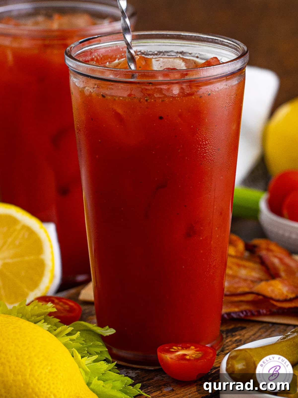 Say Her Name Thrice 5 A close-up side view of a vibrant Bloody Mary cocktail in a tall glass, beautifully garnished and ready to enjoy.