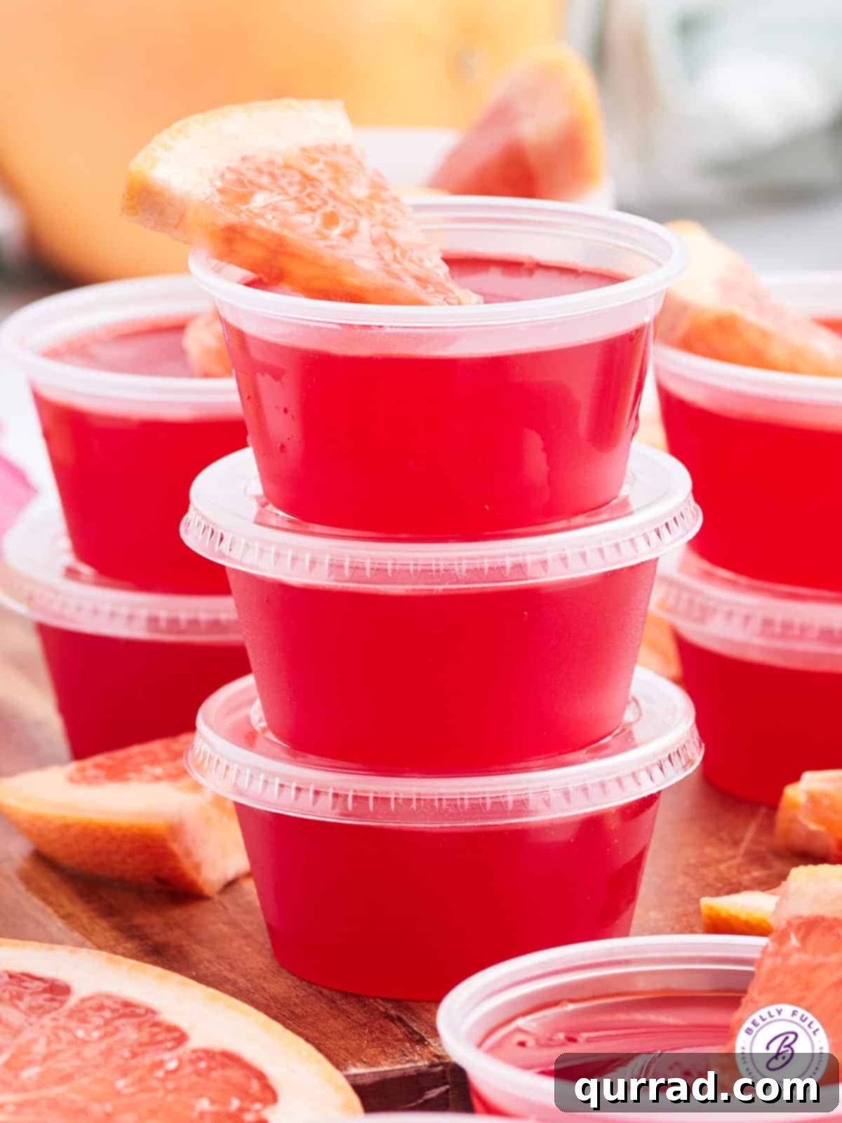 Ocean Mist Shooters 2 Three perfectly stacked Sea Breeze Jello Shots in plastic cups, ready for a party.