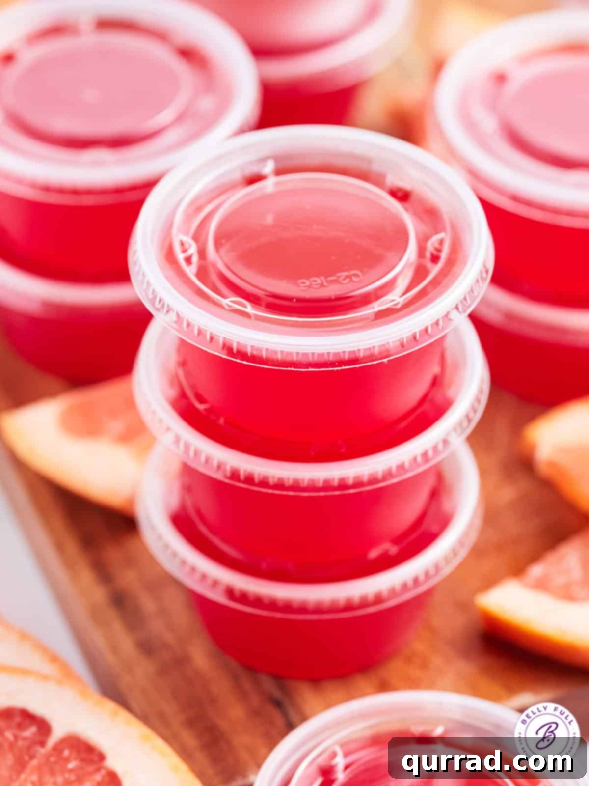 Ocean Mist Shooters 4 A stack of three red jello shots with their clear lids on, ready for storage.