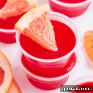 close up sea breeze jello shot garnished with a tiny grapefruit wedge