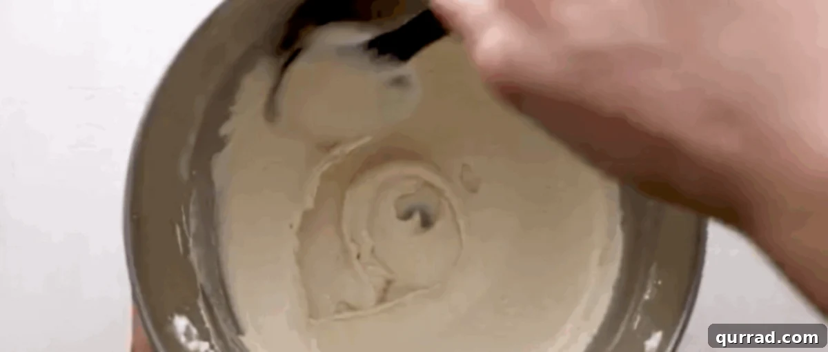 Ruby Raspberry Kisses 5 Folding dry ingredients into the meringue with a spatula using a 'J' motion.