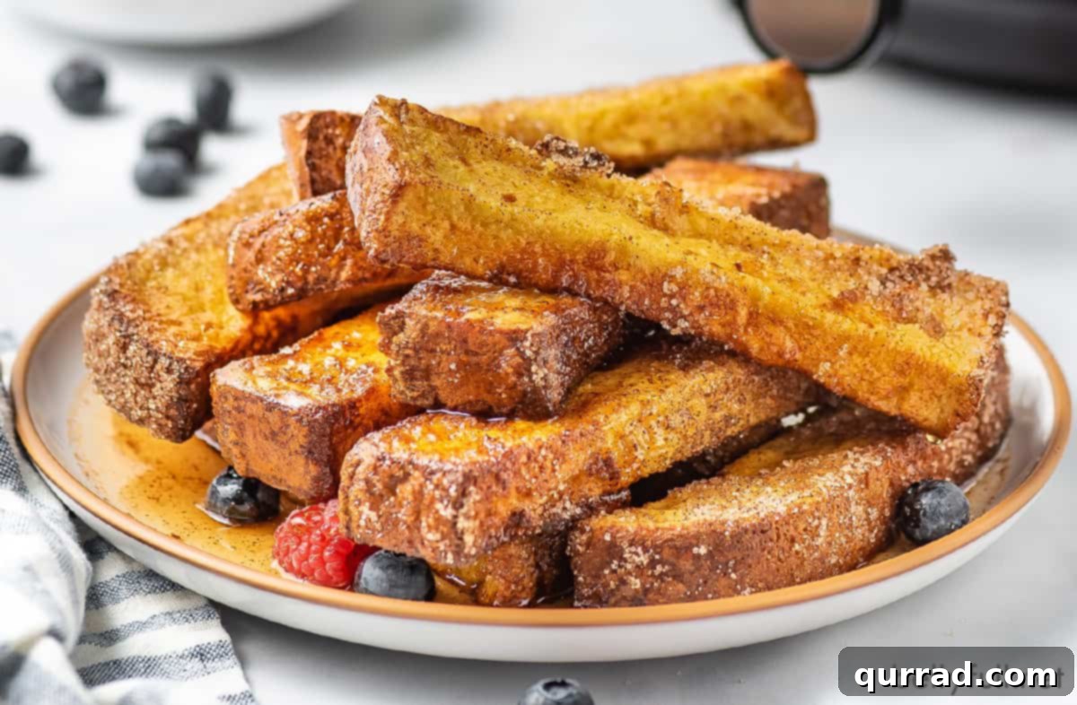 A generous platter filled with freshly air-fried French toast sticks, invitingly presented and ready for a delicious breakfast.