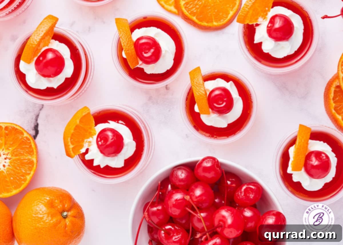 Fiesta Sunrise Jellies 4 overhead cherry jello shots with whipped cream, cherry, and orange wedge