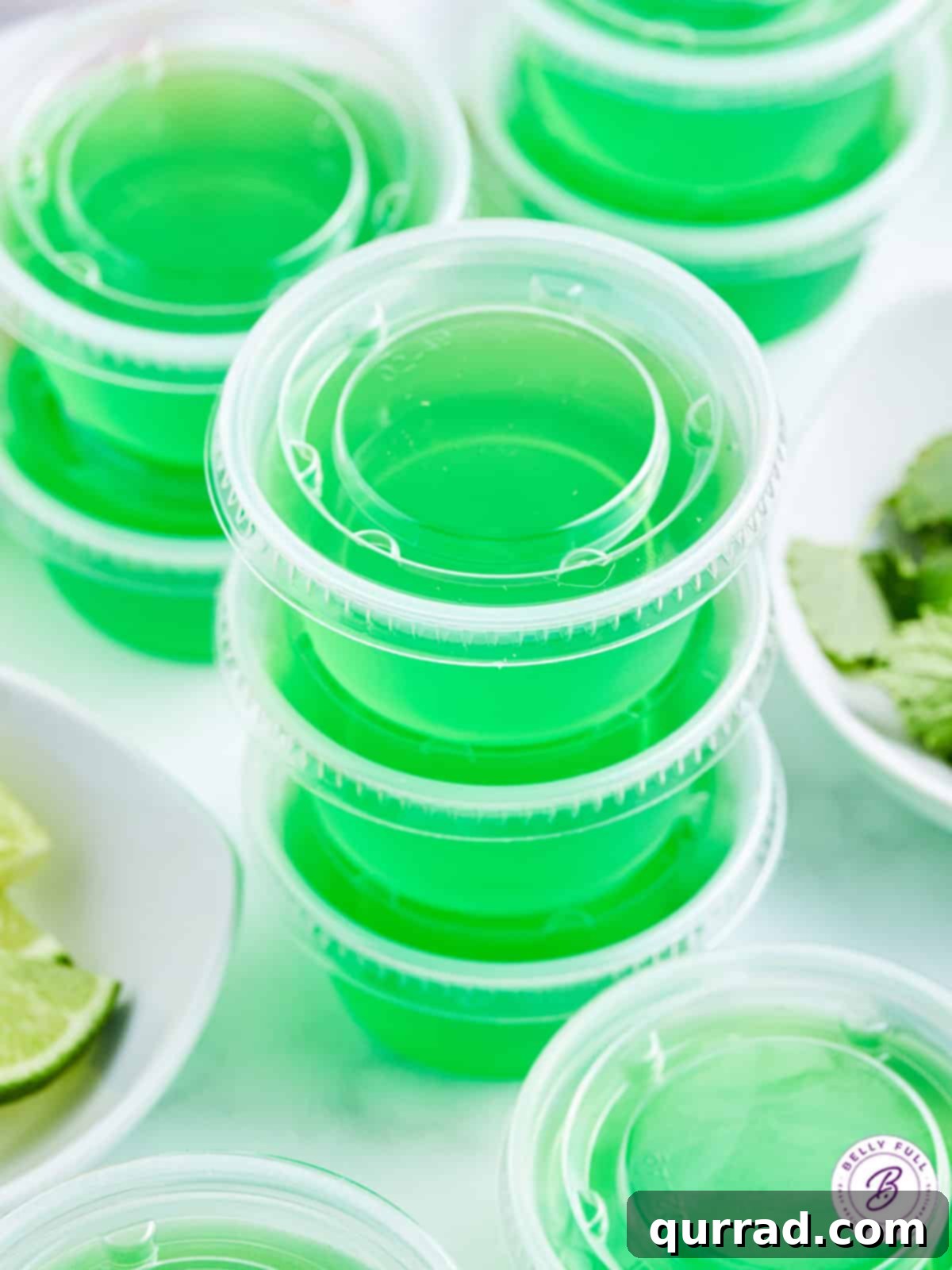 Minty Lime Gelatin Shots 3 stack of 3 green jello shots with lids