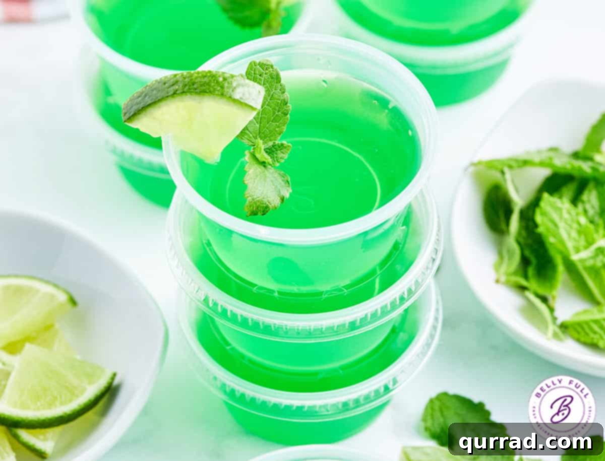 Minty Lime Gelatin Shots 5 stack of 3 green mojito jello shots garnished with lime wedge