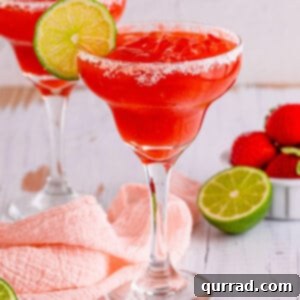Ruby Red Margarita 2 A strawberry margarita garnished with a lime slice