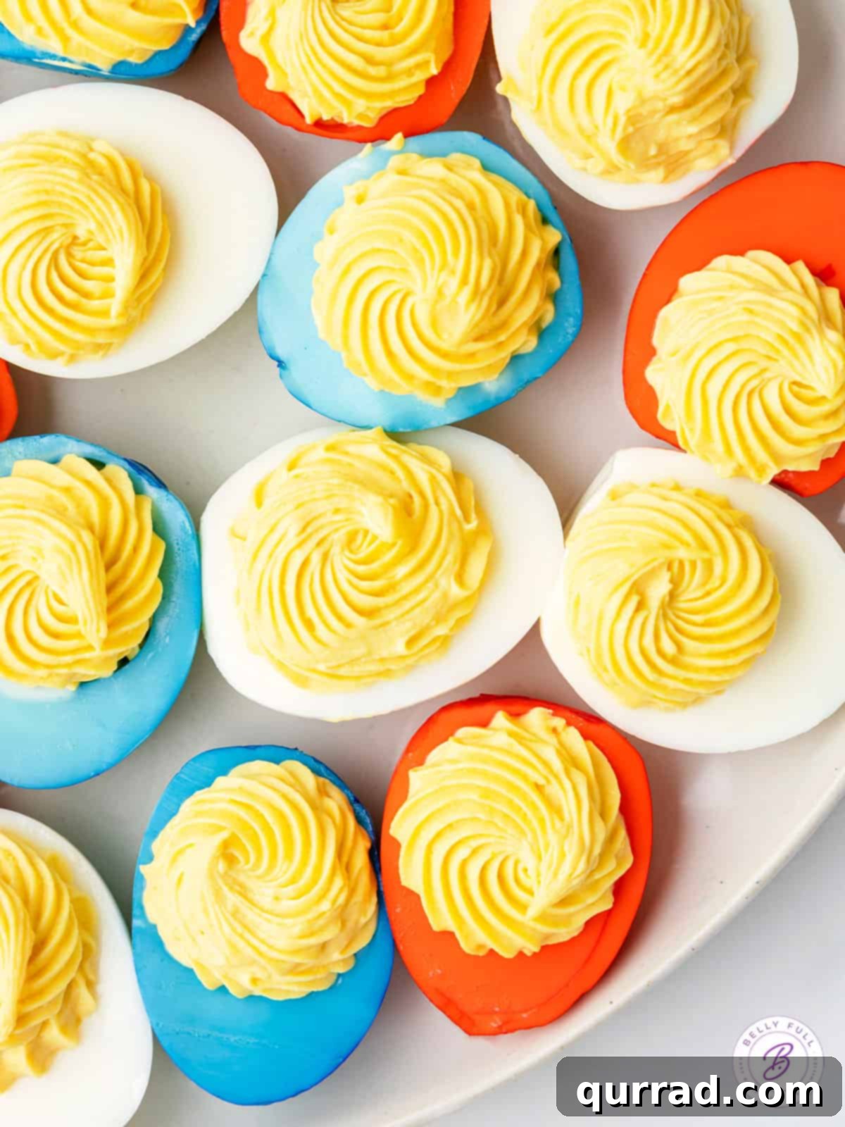 close up overhead plate of red white and blue colored deviled eggs